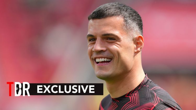 Granit Xhaka smiles whilst warming up for Bayer Leverkusen.