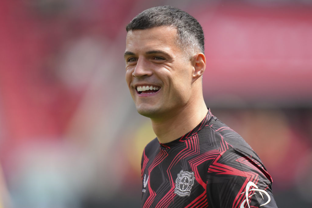 Granit Xhaka smiles whilst Bayer Leverkusen warm up.
