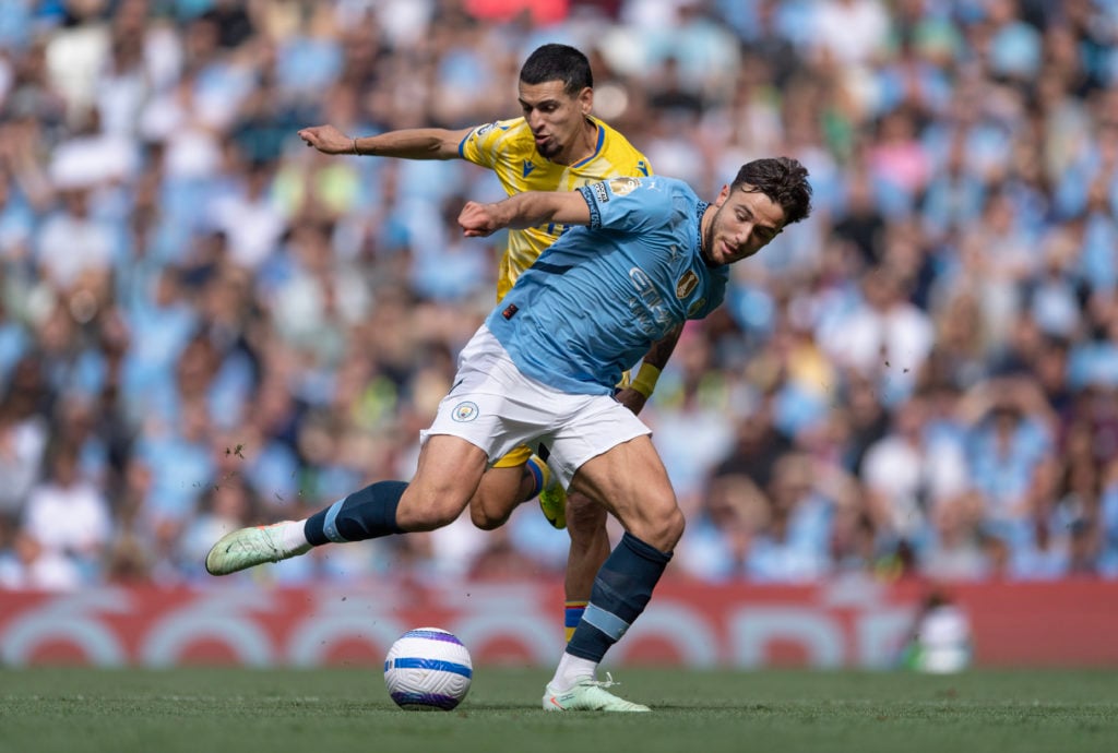 Nico Gonzalez of Manchester City and Daniel Munoz of Crystal Palace in action during the Premier League match between Manchester City FC and Crystal Palace FC at Etihad Stadium on April 12, 2025