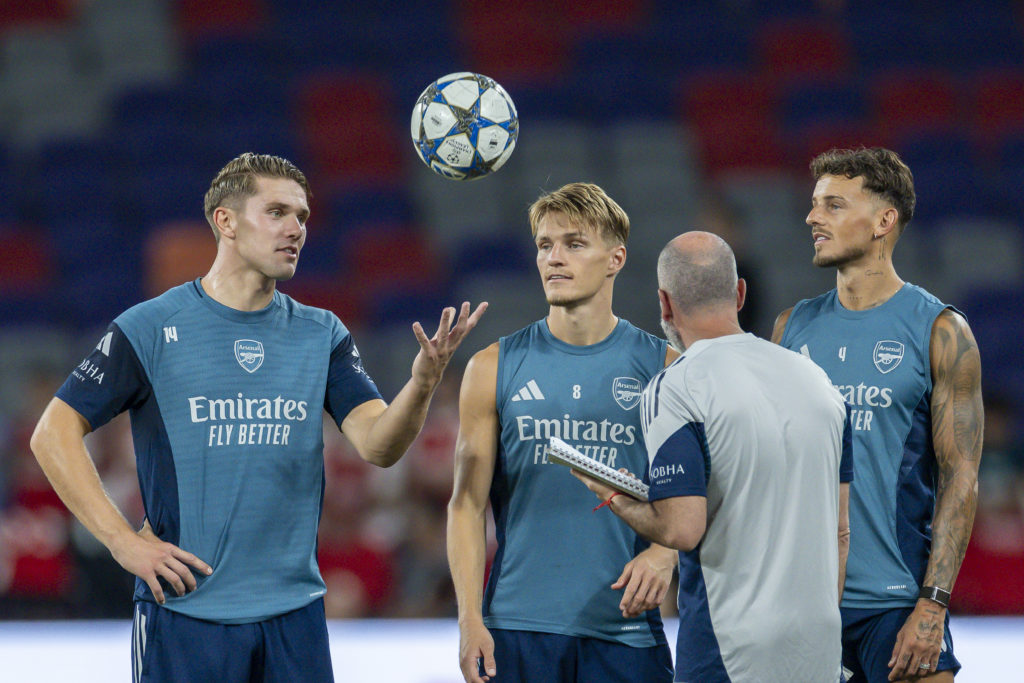 Viktor Gyokeres tosses the ball up while Martin Odegaard, Ben White and an Arsenal coach look on during an Arsenal training session