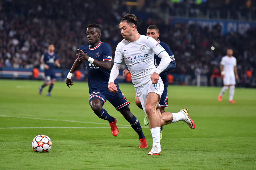 Idrissa Gueye of Paris Saint-Germain and Jack Grealish of Manchester City fight for possession