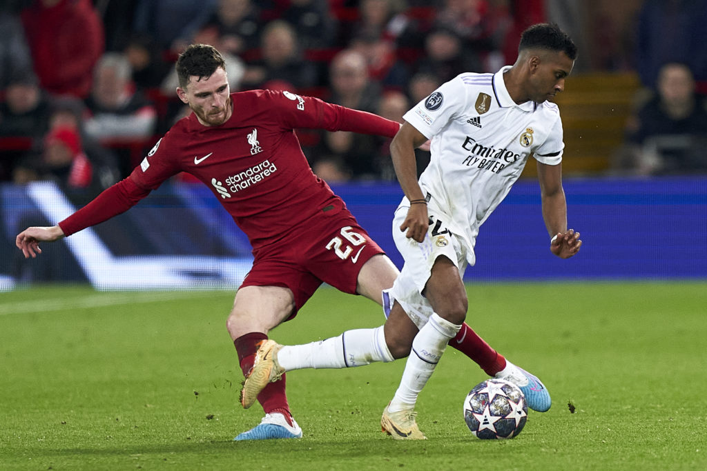 Andrew Robertson of Liverpool FC competes for the ball with Rodrygo Silva De Goes of Real Madrid during the UEFA Champions League round of 16 leg one match between Liverpool FC and Real Madrid at Anfield
