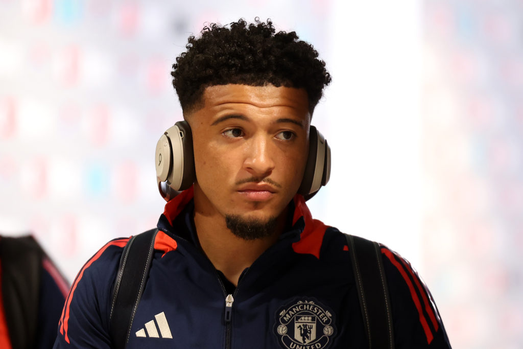 Jadon Sancho looks on in Manchester United training kit