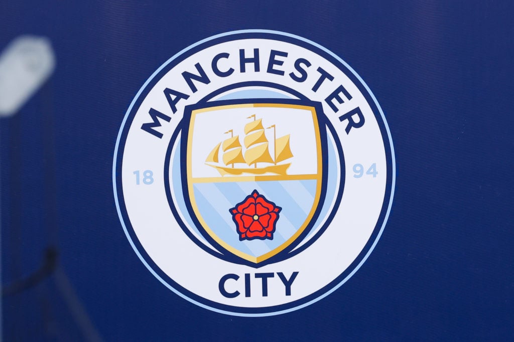 Detail of the badge of Manchester City during the UEFA Champions League 2024/25 League Knockout Play-off First Leg Training And Press Conference at Manchester City Stadium