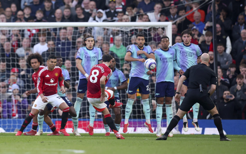 Man United captain Bruno Fernandes curls a free-kick against Arsenal.