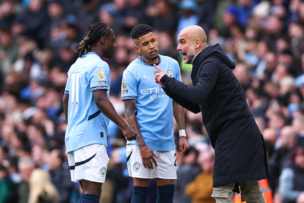 Pep Guardiola manager of Manchester City instructs Jeremy Doku of Manchester City and Savinho of Manchester City during the Premier League match between Manchester City FC and Brighton & Hove Albion FC at Etihad Stadium