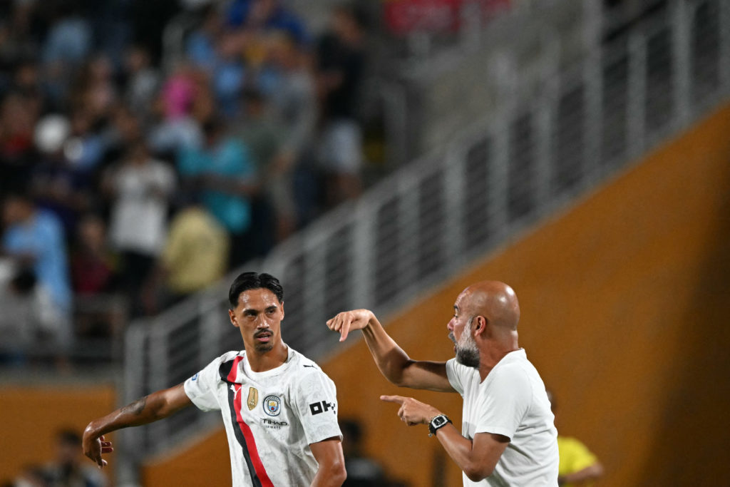 Manchester City's Spanish head coach Pep Guardiola gives instructions to Manchester City's Dutch midfielder #04 Tijjani Reijnders during the FIFA Club World Cup 2025