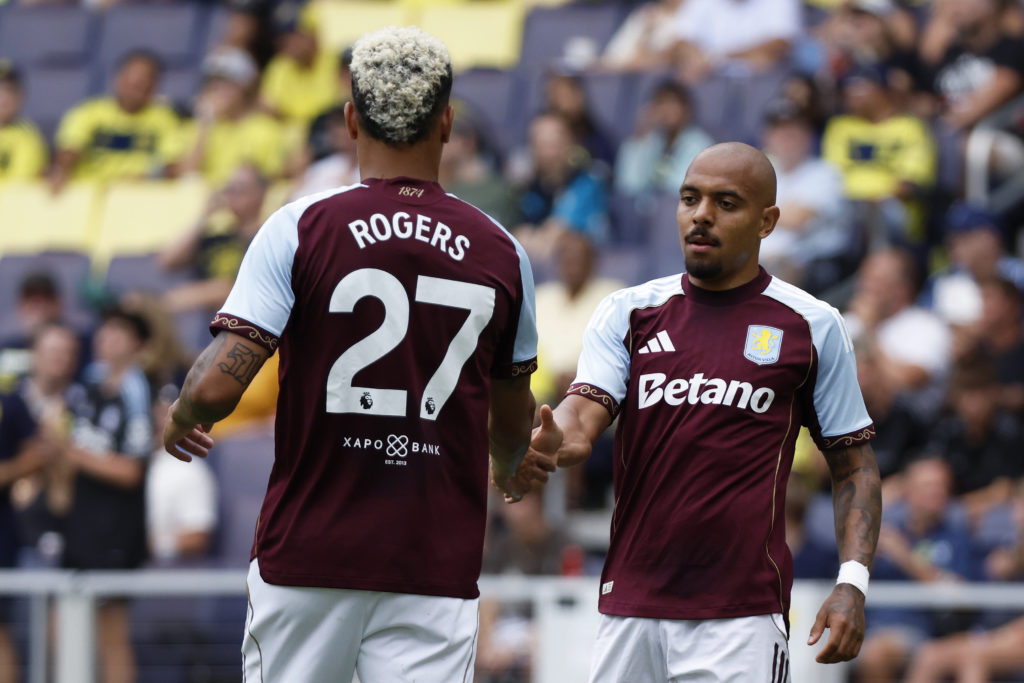 Aston Villa forward Donyell Malen gets a high five from Aston Villa midfielder Morgan Rogers