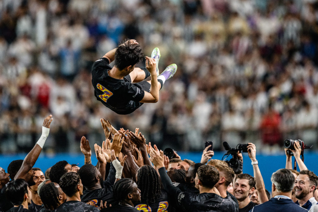 Teammates lift Tottenham Hotspur's captain Son Heung-min up in the air