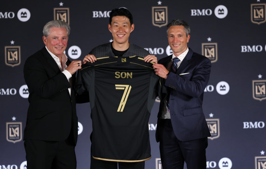 Son Hueng-Min is introduced by Los Angeles Football Club owner Bennett Rosenthal, left, and general manager John Thorrington