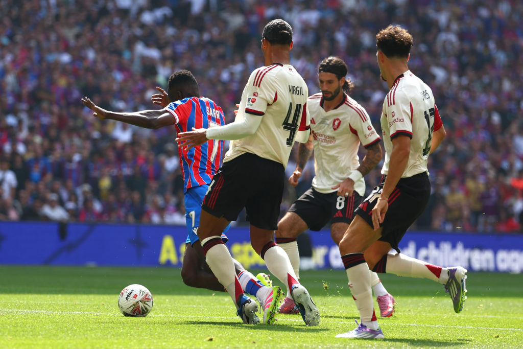 Virgil van Dijk of Liverpool fouls Ismaila Sarr of Crystal Palace to concede a penalty during the 2025 FA Community Shield match