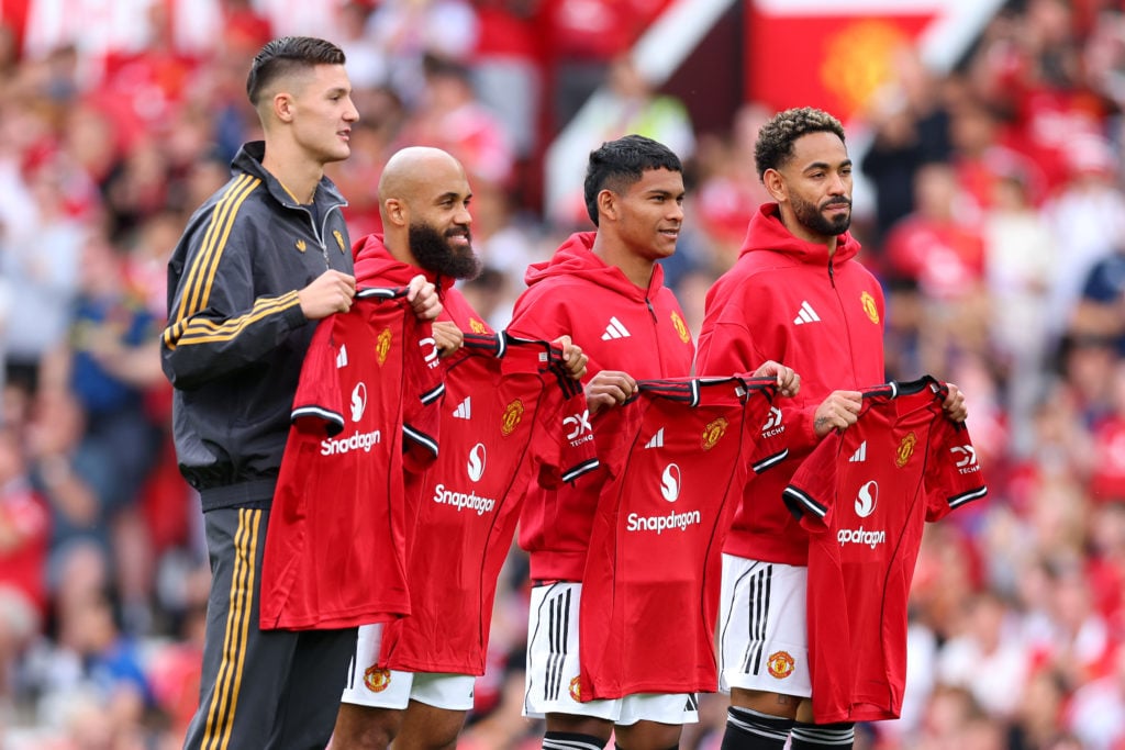 New signings Bryan Mbeumo, Benjamin Sesko, Diego Leon and Matheus Cunha of Manchester United pose for a photo while holding match shirts prior to the pre-season friendly match between Manchester United and ACF Fiorentina at Old Trafford on August 09, 2025