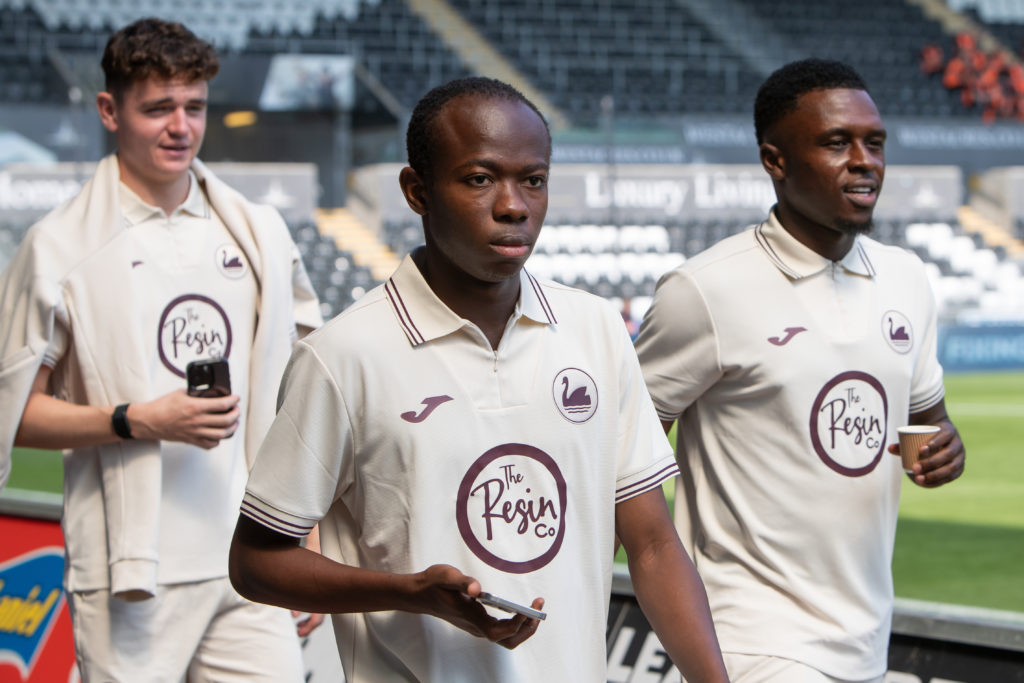 Bobby Wales (L) Malick Yalcouye (C) and Zeidane Inoussa of Swansea City