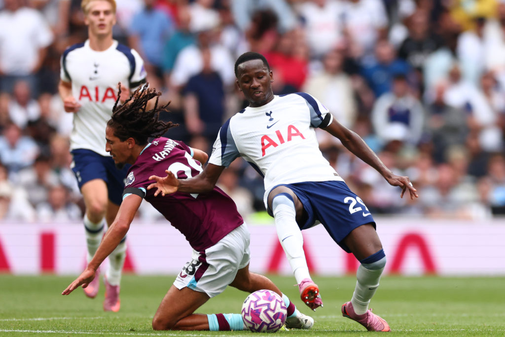 Pape Matar Sarr of Tottenham Hotspur challenges Hannibal Mejbri of Burnley during the two sides' Premier League match.