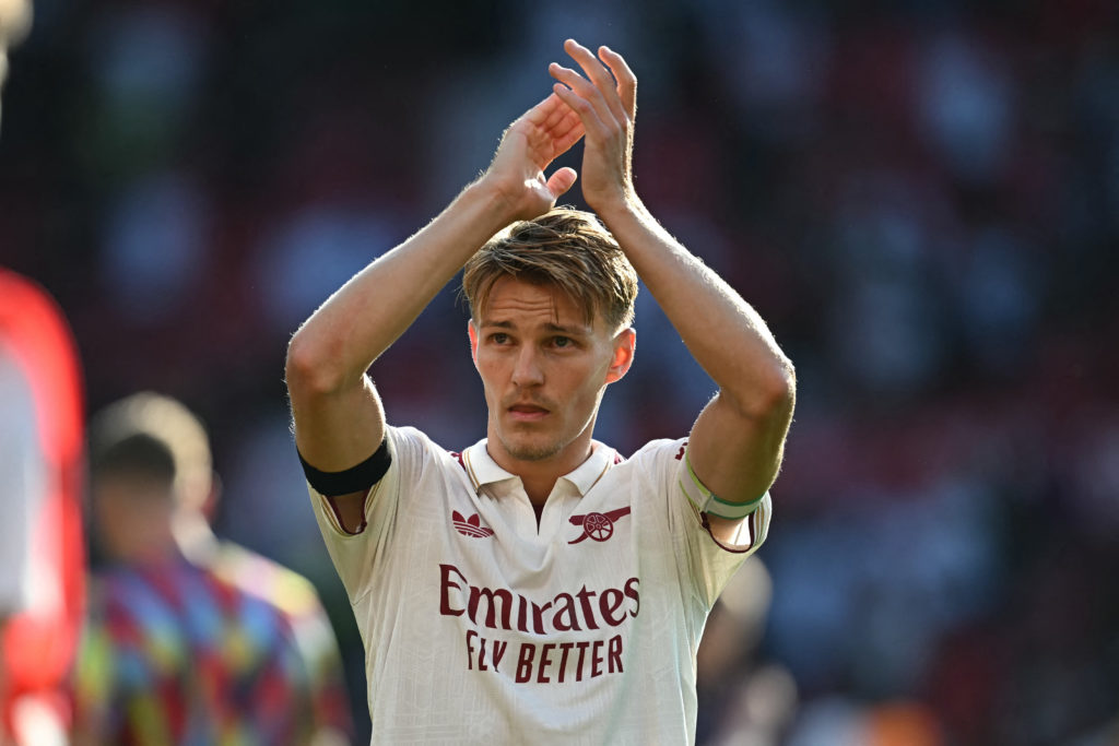 Martin Odegaard applauds Arsenal fans.