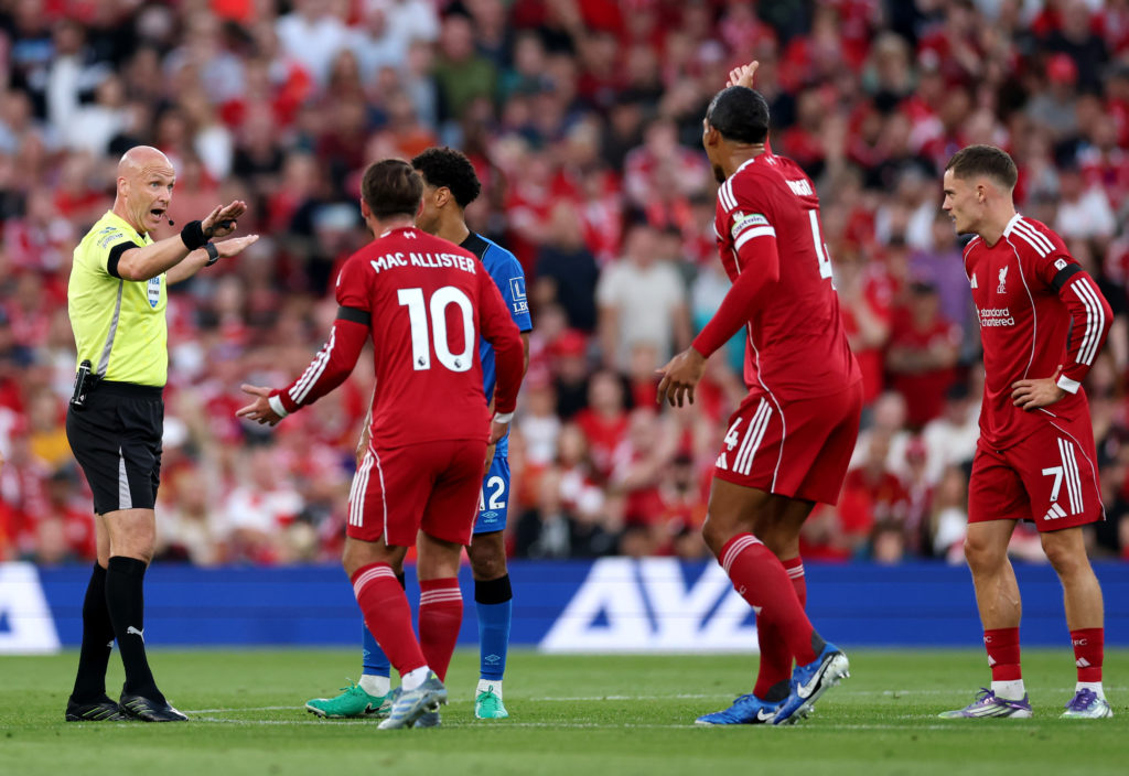 NGLAND - AUGUST 15: Referee Anthony Taylor gestures towards Alexis Mac Allister and Virgil van Dijk of Liverpool who can be seen reacting against a decision during the Premier League match between Liverpool a