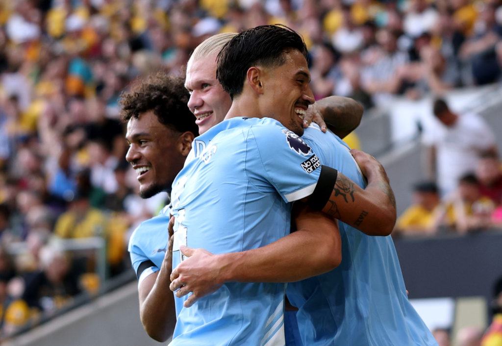 Erling Haaland of Manchester City celebrates scoring his team's third goal with teammates Tijjani Reijnders and Oscar Bobb during the Premier League match between Wolverhampton Wanderers and Manchester City at Molineux on August 16, 2025