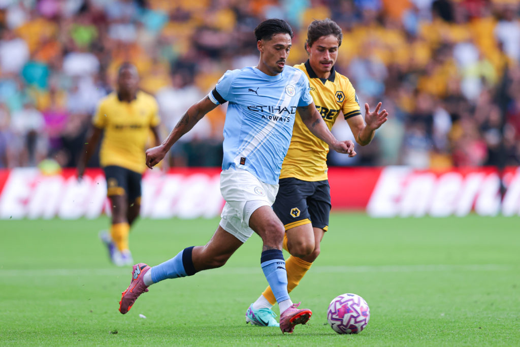 Tijjani Reijnders of Manchester City battles for possession with Hugo Bueno of Wolverhampton Wanderers during the Premier League match between Wolverhampton Wanderers and Manchester City at Molineux on August 16, 2025