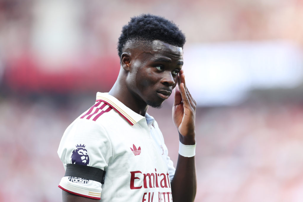 Bukayo Saka looking on while playing for Arsenal in the Premier League against Manchester United.