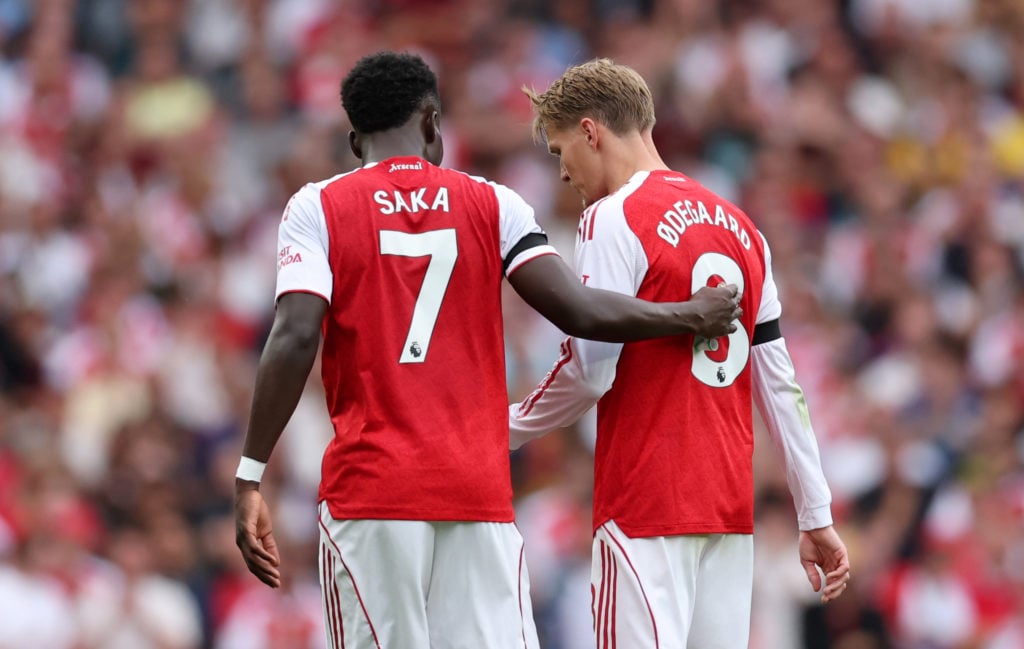 Bukayo Saka of Arsenal consoles Martin Odegaard of Arsenal as he is substituted off during the Premier League match between Arsenal and Leeds United