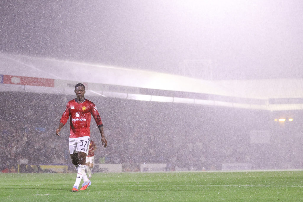 Kobbie Mainoo of Manchester United in the rain during the Carabao Cup Second Round match between Grimsby Town and Manchester United at Blundell Park