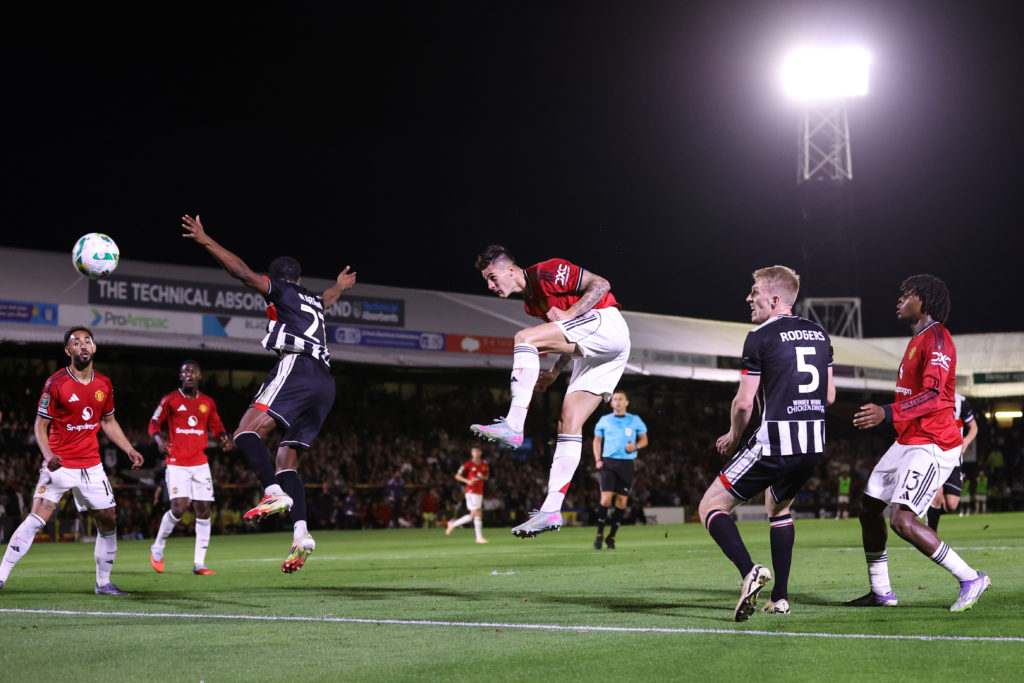 Benjamin Sesko of Manchester United heads the ball during the Carabao Cup Second Round match between Grimsby Town and Manchester United at Blundell Park