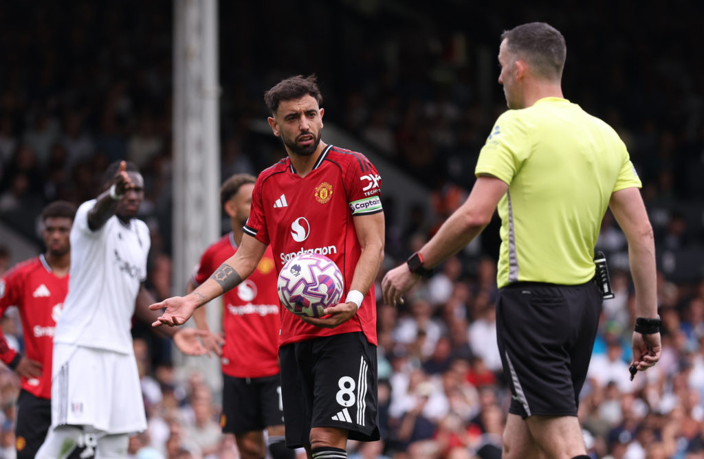 Bruno Fernandes of Manchester United with Referee Chris Kavanagh before taking a penalty during the Premier League match between Fulham and Manchester United at Craven Cottage