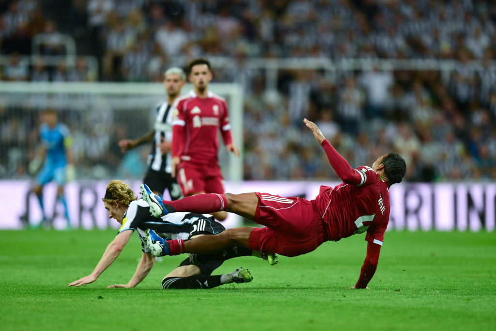 Anthony Gordon of Newcastle United (10) fouls Virgil van Dijk of Liverpool FC (4) during the Premier League match between Newcastle United and Liverpool at St James' Park.