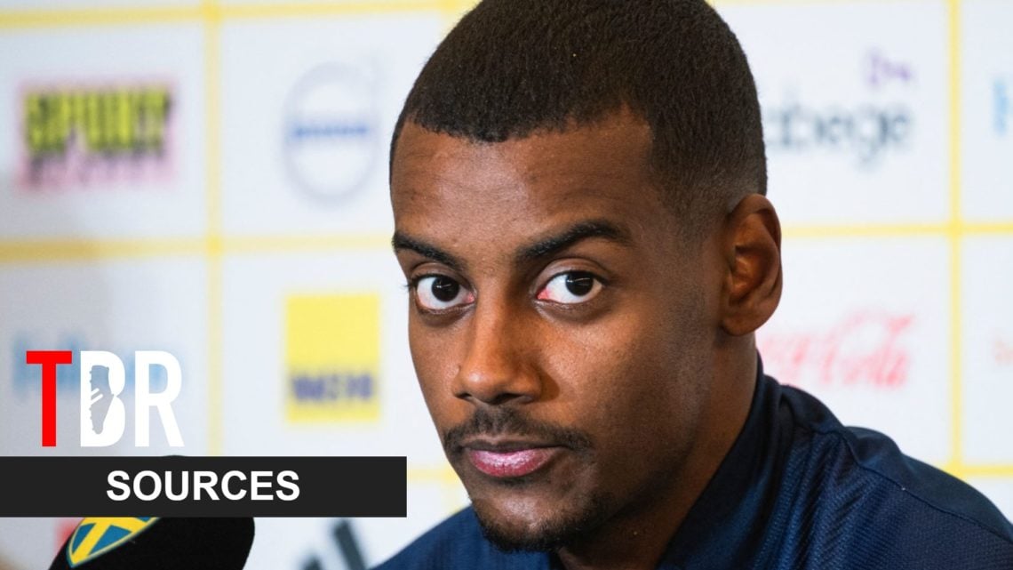 Image of Alexander Isak looking on before a Newcastle game, overlaid a TBR Sources banner