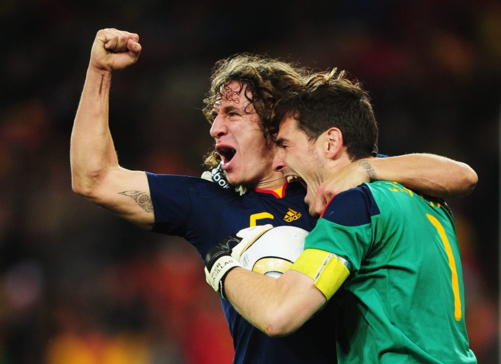 Carles Puyol and Iker Casillas of Spain celebrate winning the World Cup after the 2010 FIFA World Cup South Africa Final match between Netherlands and Spain