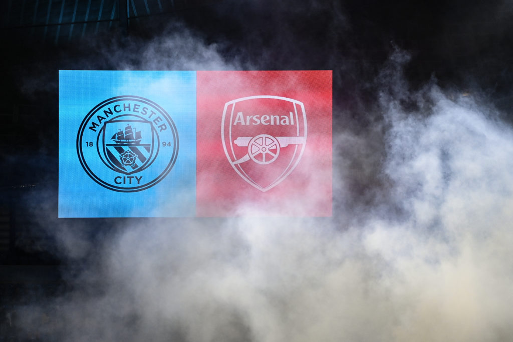 The scoreboard at the Etihad Stadium showing the badges of Manchester City and Arsenal
