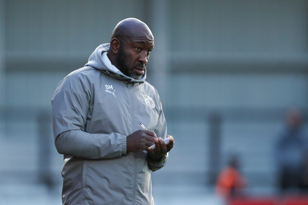 Darren Moore takes notes during Salford City vs Port Vale