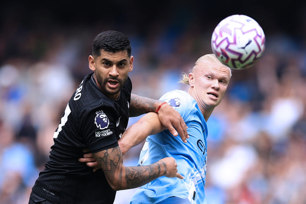 Tottenham Hotspur defender Cristian Romero in action against Manchester City's Erling Haaland.