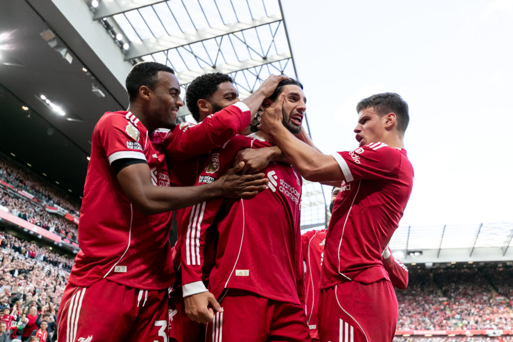 Liverpool players celebrate after scoring against Arsenal