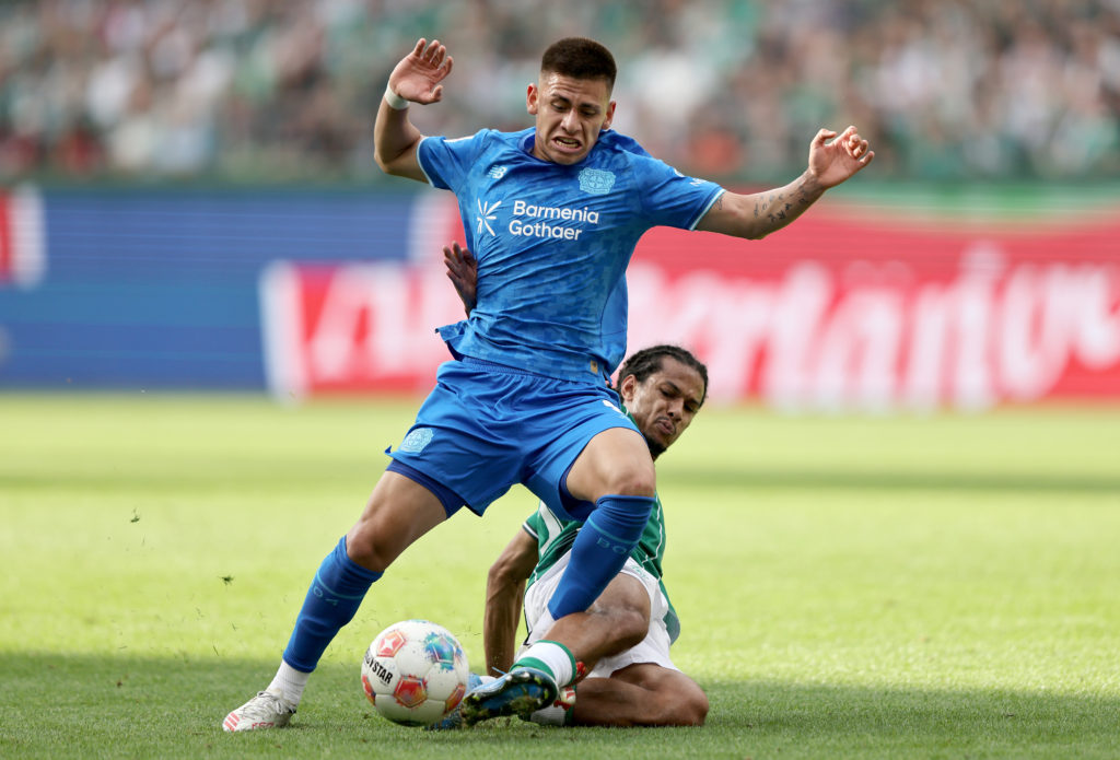 Claudio Echeverri of Bayer Leverkusen is challenged by Isaac Schmidt of Werder Bremen during the Bundesliga match between SV Werder Bremen and Bayer 04 Leverkusen at Weserstadion on August 30, 2025