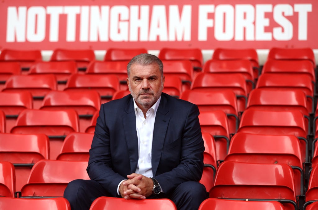 Ange Postecoglou poses for a photo in the stands as he unveiled as Nottingham Forest head coach at City Ground