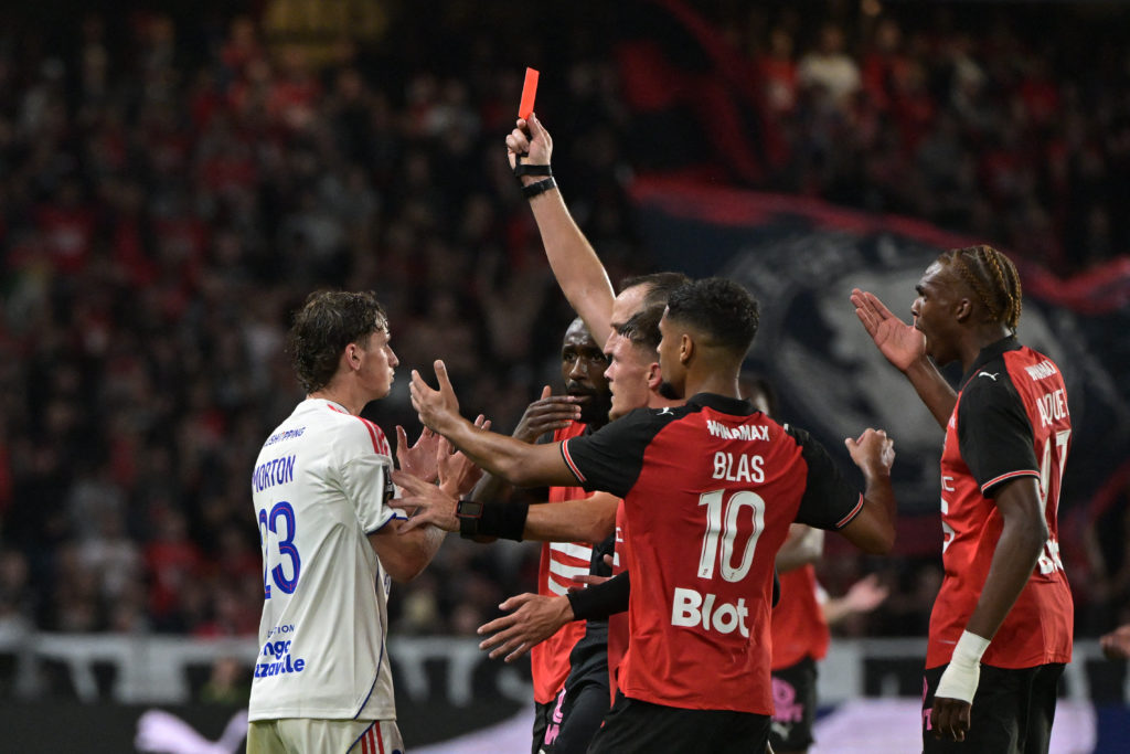 Lyon's English midfielder #23 Tyler Morton (L) receives a red card during the French L1 football match between Stade Rennais FC and Olympique Lyonnais (OL) at the Roazhon Park stadium.