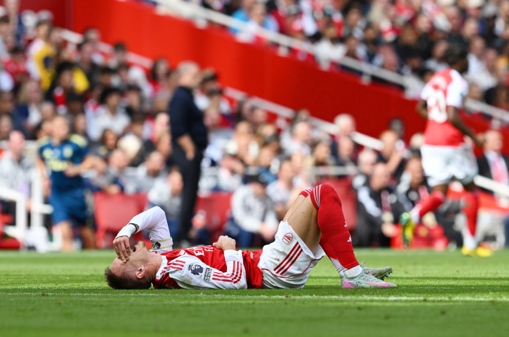 Martin Odegaard of Arsenal goes down with an injury during the Premier League match between Arsenal and Nottingham Forest at Emirates Stadium