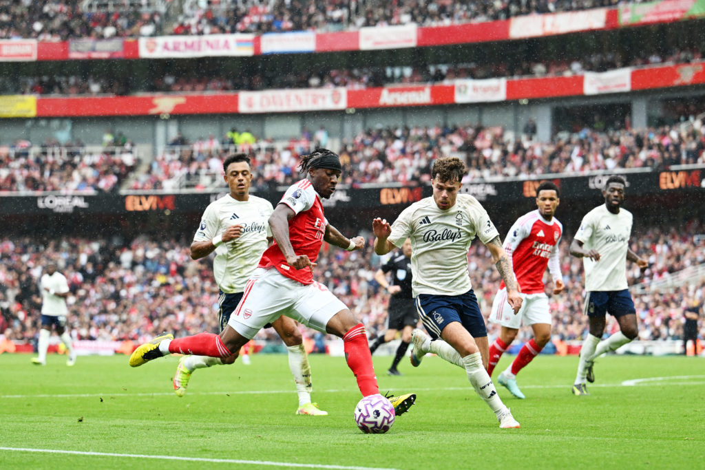 Noni Madueke of Arsenal is challenged by Neco Williams of Nottingham Forest during the Premier League match between Arsenal and Nottingham Forest