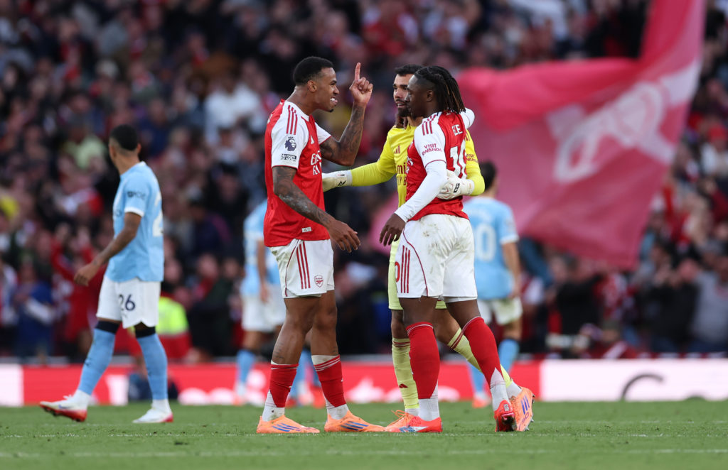 Arsenal players celebrate scoring against Manchester City