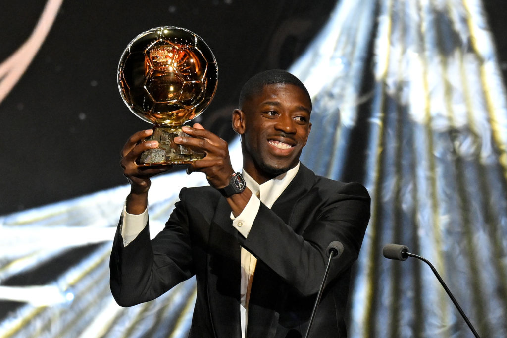 Ousmane Dembele holds aloft the Ballon d'Or trophy after being crowned the winner at Theatre du Chatelet