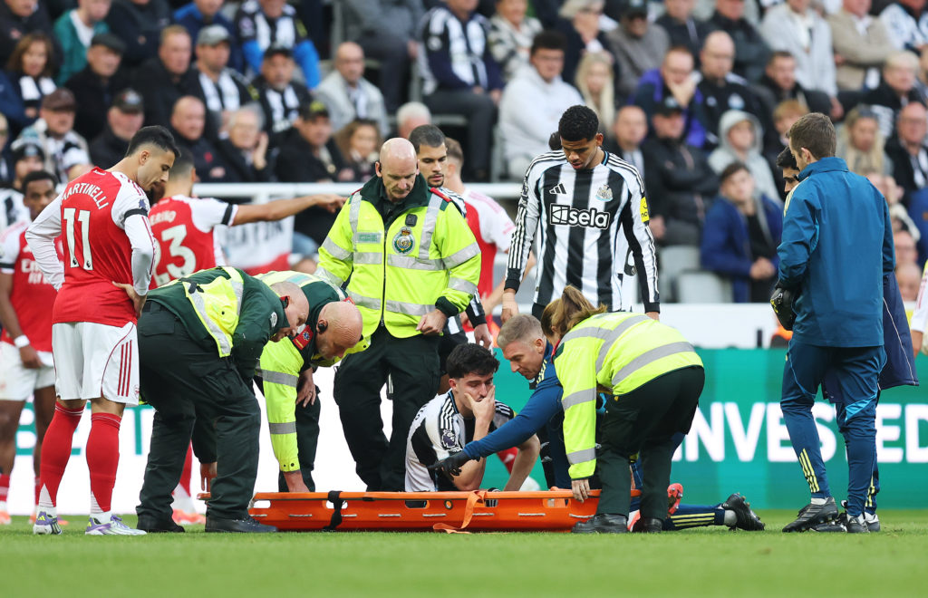 Tino Livramento of Newcastle United reacts as he is stretchered off