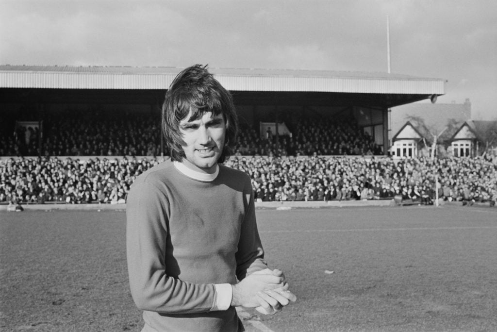 George Best poses during a game between Manchester United and Northampton Town