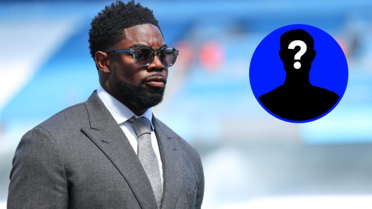 Micah Richards looks on before a Premier League match alongside a mystery player inset