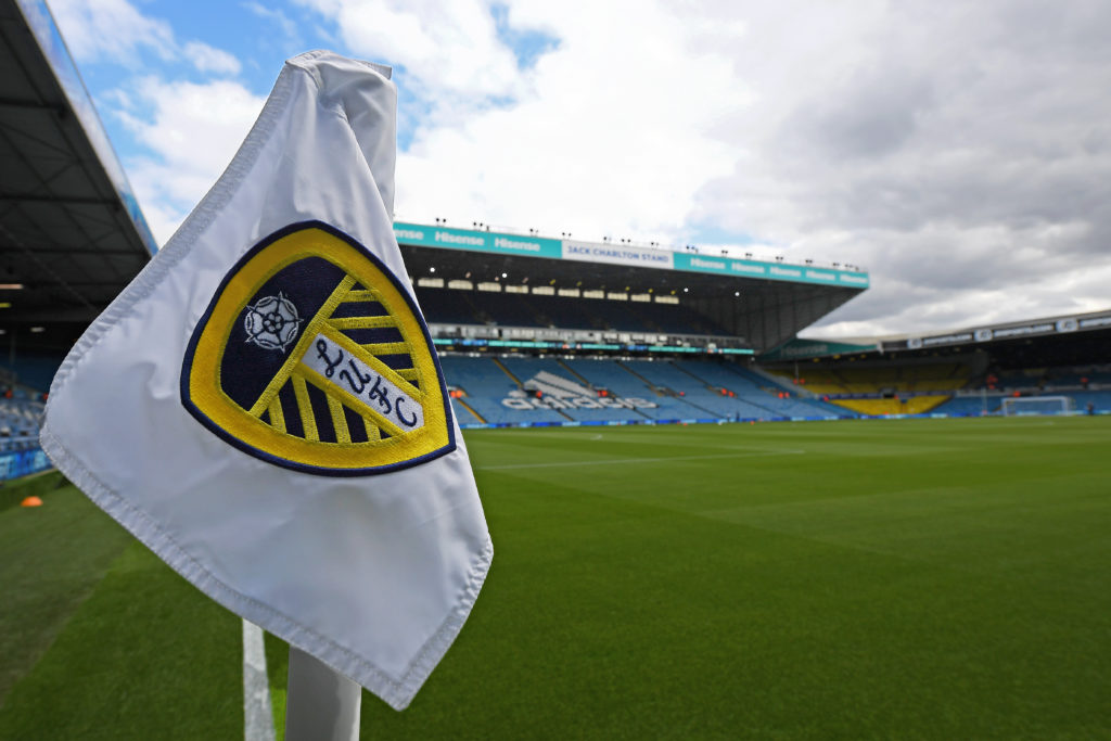 A general view of Elland Road, with a closeup shot of the Leeds United badge on a corner flag in the foreground