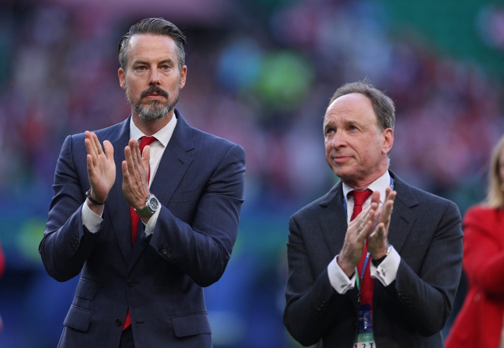 Josh Kroenke and Tim Lewis applaud at Arsenal's Emirates Stadium