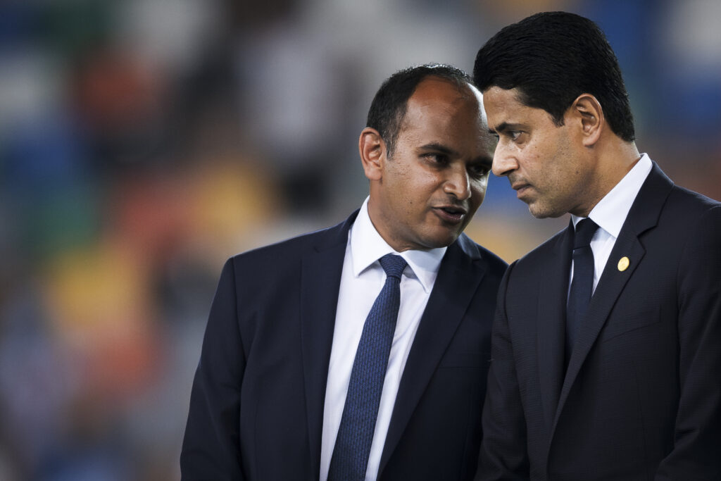 Vinai Venkatesham (L), CEO of Tottenham Hotspur FC, speaks to Nasser Al-Khelaifi