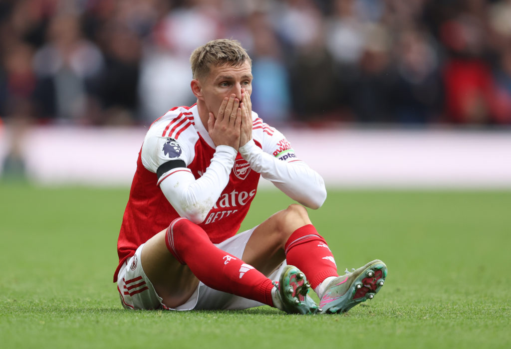 Martin Odegaard reacts after suffering an injury for Arsenal