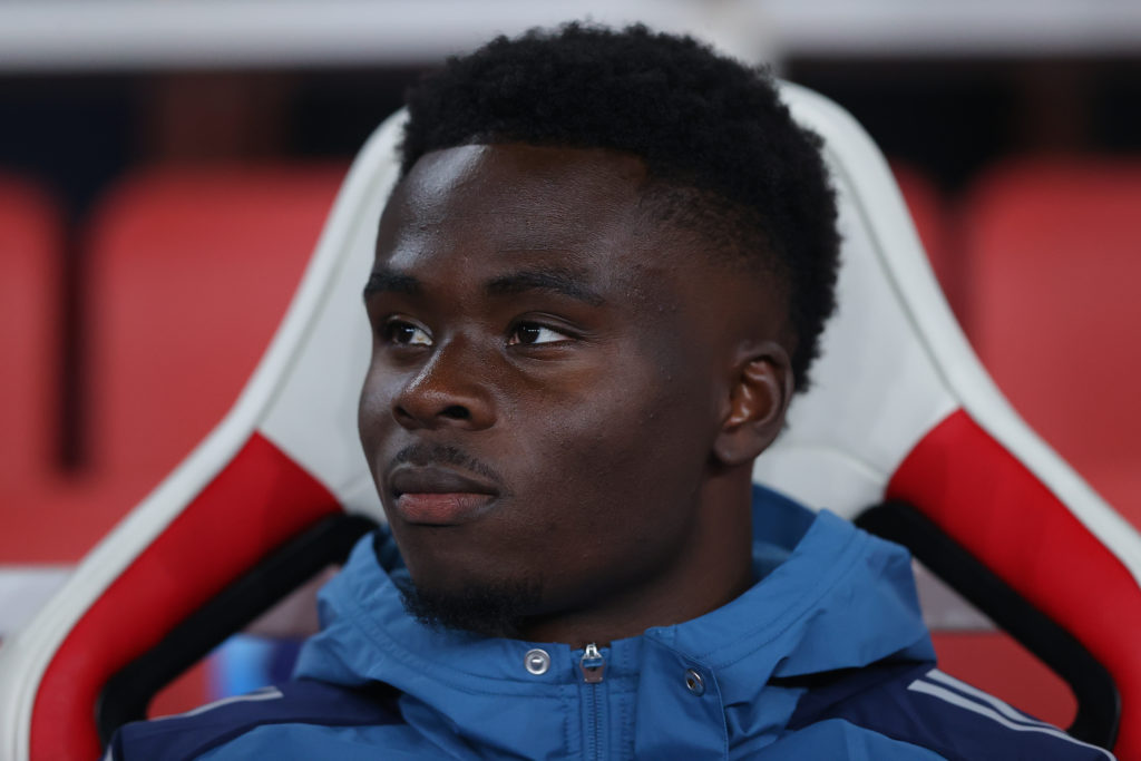 Bukayo Saka looks on from the bench during Arsenal's Champions League win against Olympiacos at the Emirates