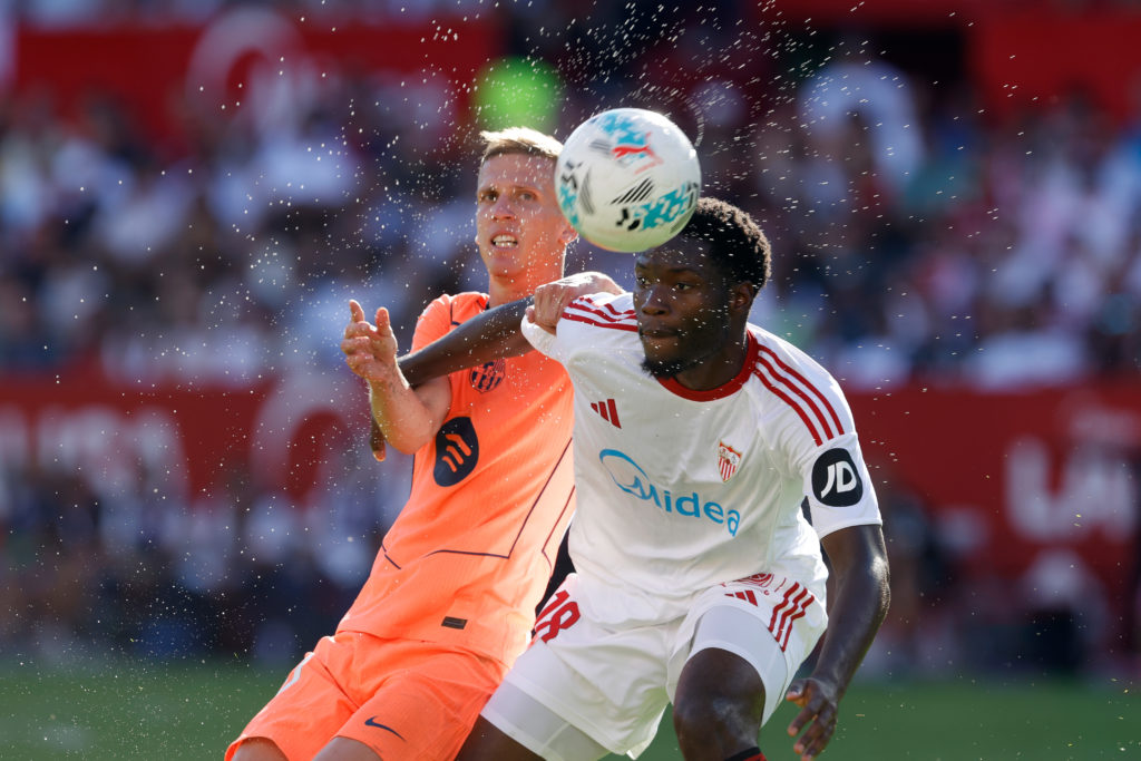 Sevilla midfielder Lucien Agoume competes with Barcelona's Dani Olmo for the ball